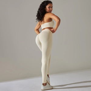 Detail of light beige seamless ribbed knit yoga set showing texture and one-shoulder design