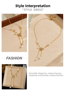 Close-up of golden bow pendant with pearls and crystal tassel chain on beige texture