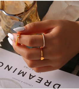 Detailed view of 18K gold plated stackable rings with heart and sparkling zircon accents