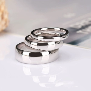 Polished S925 sterling silver rings in three different widths stacked on white surface