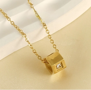 Detail of 18k gold plated stainless steel necklace with hollow cube zircon pendant
