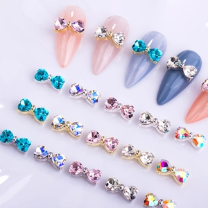 Detailed view of colorful bow-knot nail art charms with rhinestones and alloy bases