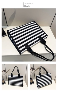 Detail of striped canvas tote bag showing top view with snap button and reinforced handles