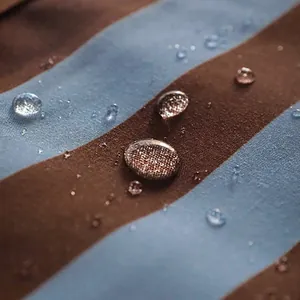 Water-repellent brown and blue striped cotton kitchen apron with breathable fabric material