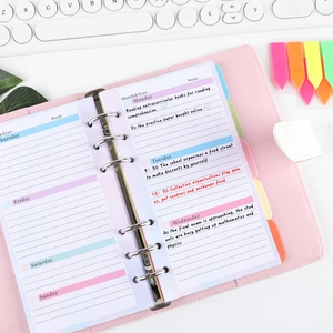 Close-up of A6 pink PU leather 6-ring binder showing weekly planner refill and english notes