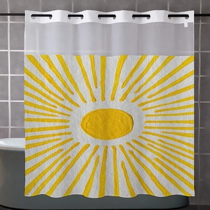 Close-up of yellow waffle weave shower curtain fabric with sunburst pattern and clear hooks