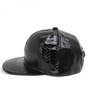 Close-up of black crocodile pattern faux leather baseball cap with glossy textured finish