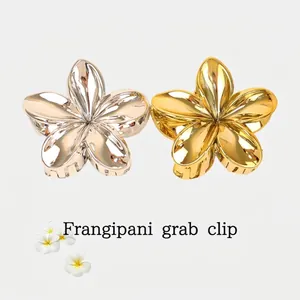 Elegant gold and silver frangipani flower hair claw clips with polished metal finish