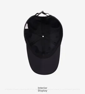 Detail view of the black cotton baseball cap interior with adjustable buckle and sweatband