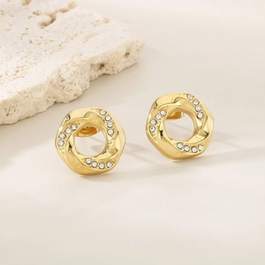 Detailed close-up of 18K gold plated hexagonal earrings with sparkling inlaid rhinestones