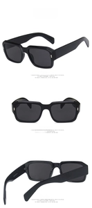 Detail view of bold black square sunglasses with specifications and dark grey lenses