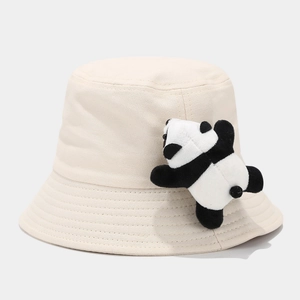 Detail of cute panda plush doll decoration on beige canvas kids sun bucket hat