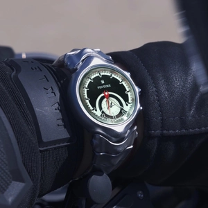 Retro Y2K irregular silver quartz watch with black dial on a motorcycle rider wrist