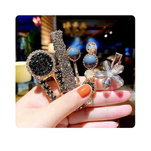 Close-up of 5-piece luxury hair clip set featuring pearls, rhinestones, and floral designs