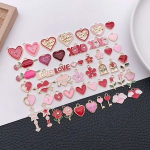 Close-up of assorted pink and red enamel heart charms for DIY jewelry making