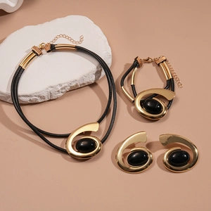 Parure de bijoux spirale dorée moderne avec pierres ovales noires, collier et boucles