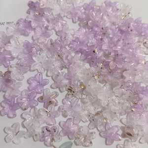 Macro shot of purple and white five-petal flower beads with golden foil specks