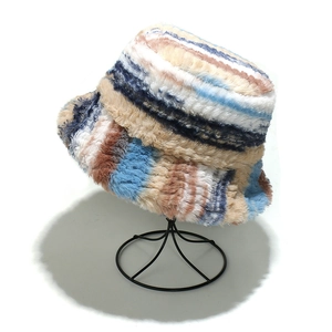 Macro shot of colorful faux fur texture on a warm striped bucket hat with fluffy details