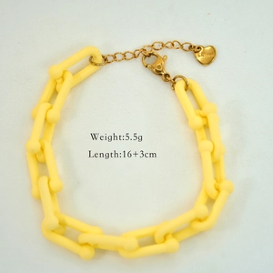 Detail of yellow acrylic link bracelet with S.Steel heart tag and lobster clasp