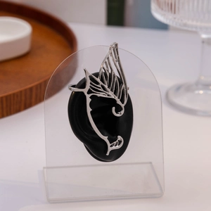 Detail view of silver butterfly wing ear cuff with hollow texture on ear model