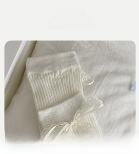 Detail of high elasticity sock mouth with white lace trim and sweet ribbon bow decoration
