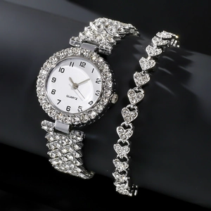 Elegant silver quartz watch with rhinestone-studded heart bracelet set on black background