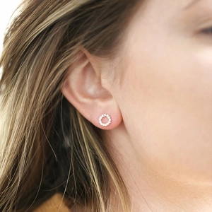 Elegant silver-toned hollow circle earrings with micro-set white zircon on female model
