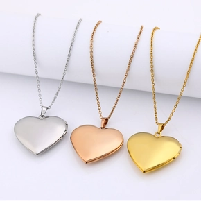 Three heart-shaped locket pendants in gold silver and rose gold on delicate chains