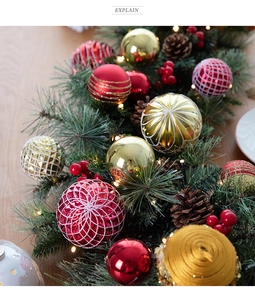 Close-up of red and gold Christmas ornaments with warm LED lights and pine branches