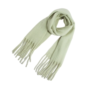 Close-up of thick light green mohair scarf with soft plush texture and fringe detail