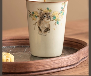 Detailed view of hand-painted tabby cat on Ru Kiln crackle glaze ceramic tea cup