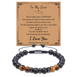 Close-up of handmade tiger eye and matte onyx beaded bracelet with gift card message