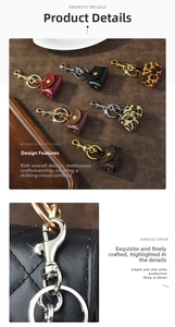 Macro detail of leather mini pouch keychain showing stitching and metal lobster clasp