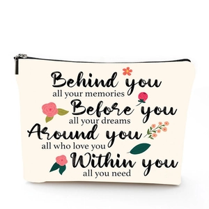 Detailed view of linen cosmetic bag with motivational quote and floral print design
