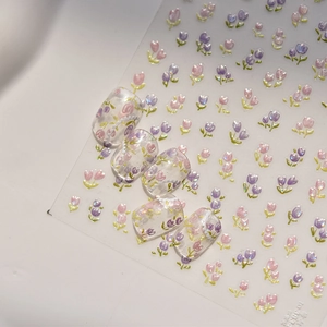 Detail of tulip nail stickers featuring shell luster and pink floral patterns