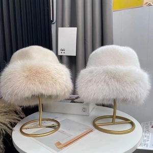 Lush faux fur winter bucket hats in white and beige for premium cold weather warmth