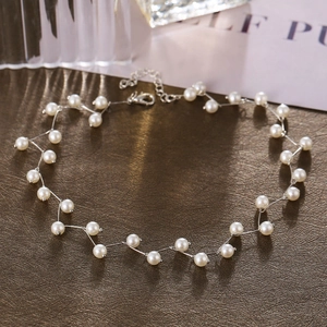 Detailed view of white pearl choker with silver wavy links and adjustable lobster clasp