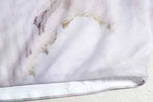 Macro shot of marble print knit fabric and detailed double-needle lockstitch edge