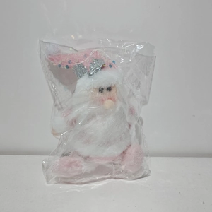 Detail of a pink plush Santa Claus doll with sparkly sequins in clear plastic packaging