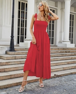 Detail of red backless maxi dress featuring pleated bust and tiered ruffle skirt layers