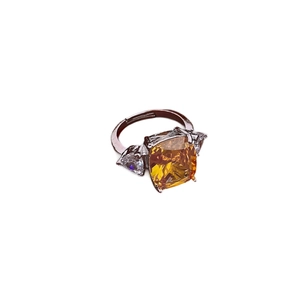 Minimalist silver ring with yellow emerald-cut gemstone and triangular zircon accents