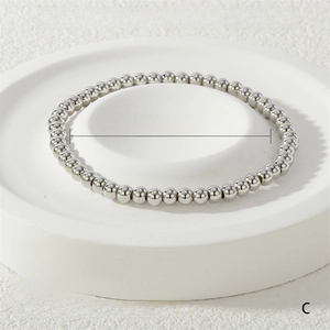 Detail of 4mm white gold stretch bracelet with 51 solid metal beads on a stone tray