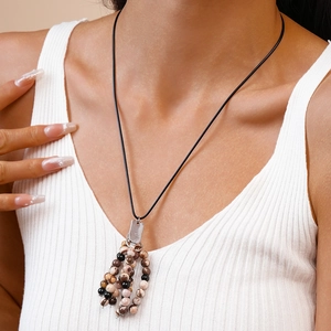 Detailed close-up of a vintage ethnic beaded necklace worn on a female model's neck