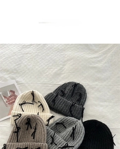 Detail analysis of knit beanies with black ribbon bows in five stylish winter colors