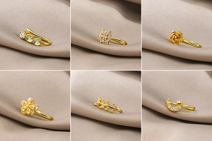 Detail shots of assorted gold-plated ear cuffs featuring star, moon, and floral designs