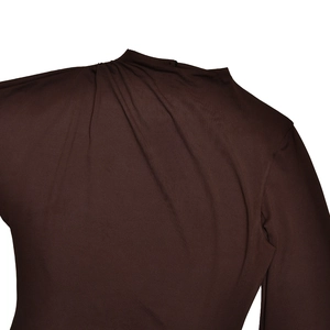 Detail of soft pleated texture on the neckline and shoulder of a brown maxi dress
