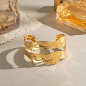 Gold plated stainless steel wavy double-layered cuff bracelet with hammered liquid metal texture