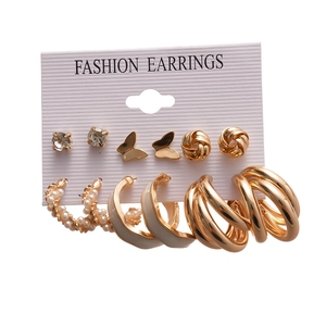 12-piece gold geometric earring set with pearls and butterfly studs on a white card