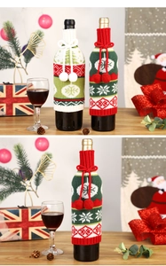 Detail showing knitted Christmas wine bottle covers with snowflakes and tree patterns