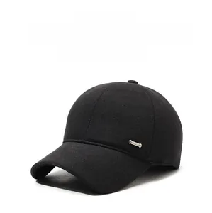 Close-up of black wool baseball cap featuring ear flaps and metal hardware detail